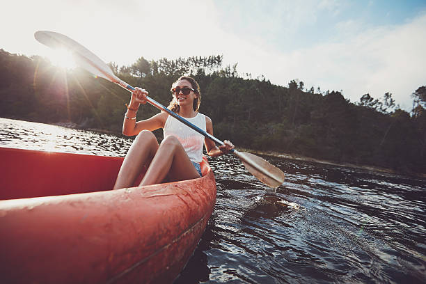istock Young woman canoeing in a lake 516756758