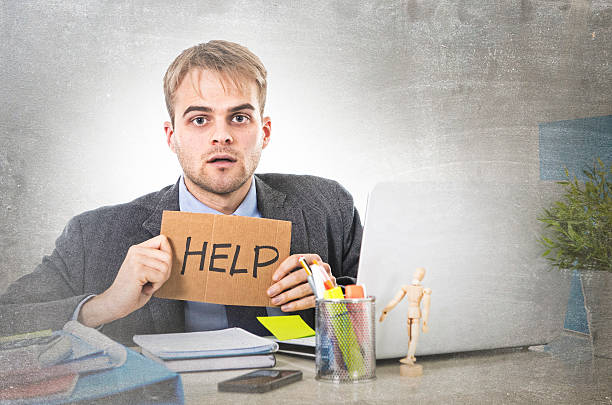 istock young desperate businessman holding help sign looking worried suffering stress 516756920