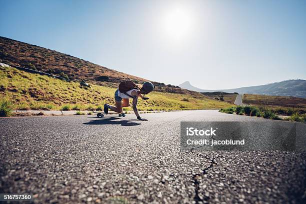Female Skater Practicing Skateboarding On Rural Roads Stock Photo - Download Image Now