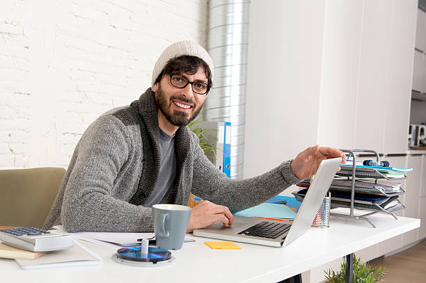 istock young hispanic hipster businessman working at computer home office 516757670