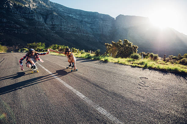 istock Couple skating down the road on a sunny day 516757848