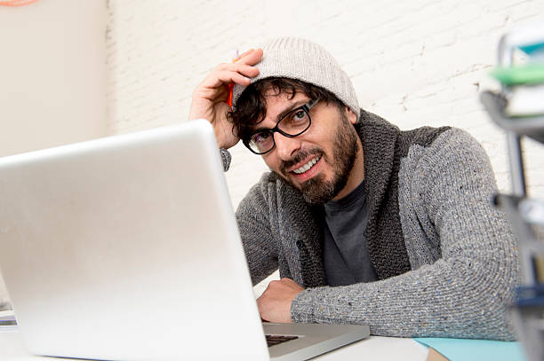 istock young hispanic hipster businessman working at computer home office 516759896