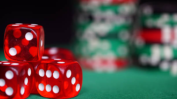 istock Red dice and casino chips on green table 516760212