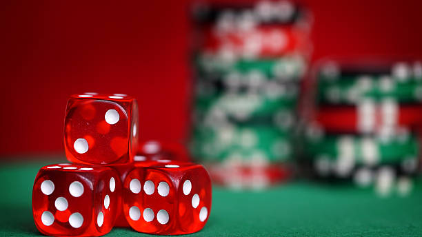 istock Red dice and casino chips on green table 516760300