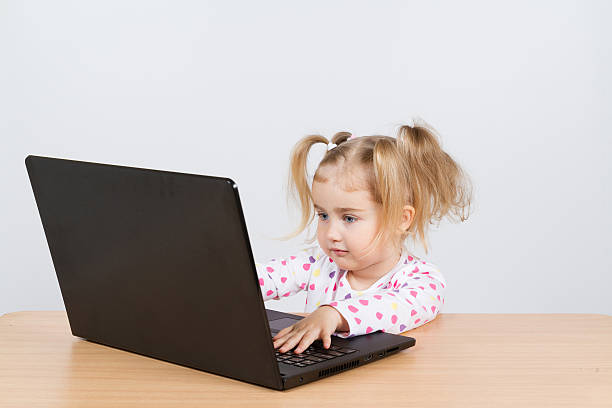 istock little girl at the computer. 516761112