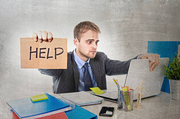 istock young desperate businessman holding help sign looking worried suffering stress 516761588