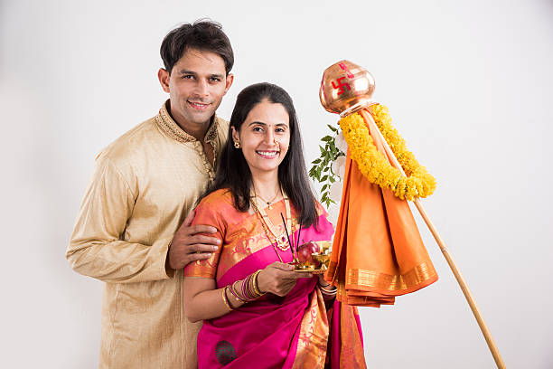istock smart indian couple performing gudhi padwa puja 516762404