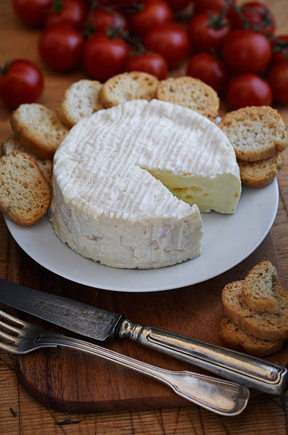 istock Camembert on wooden table 516762972
