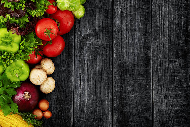Organic Vegetables on a Black Wooden Background