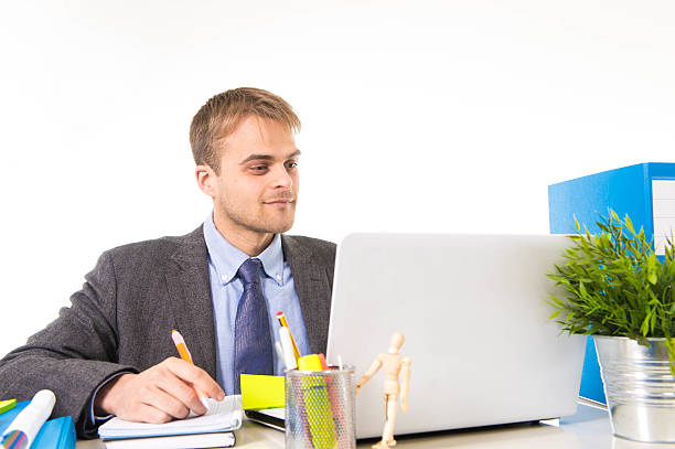 istock attractive businessman working busy with laptop computer at office desk 516763420