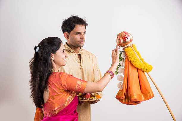 istock smart indian couple performing gudhi padwa puja 516763440