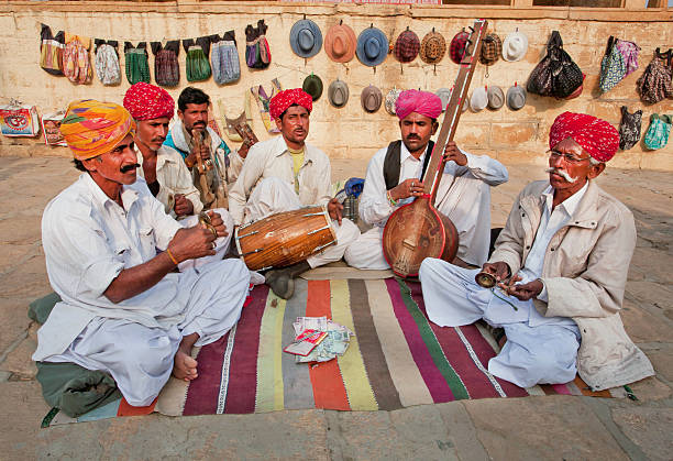Street musicians play music on different traditional instruments Jodhpur, India - February 2: Street musicians play music on different traditional instruments outdoor on February 2, 2015 in Rajasthan. Jodhpur with population 1,290,000 people, is center of Marwar region india indian culture market clothing stock pictures, royalty-free photos & images