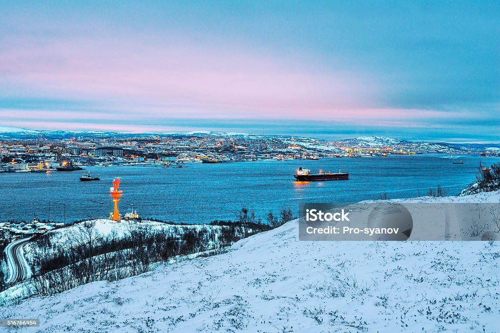The port city of Murmansk in the evening. The city of Murmansk is located in the North of Russia, on the shore of the Kola Bay (Barents Sea) - the Arctic Circle. Murmansk Stock Photo