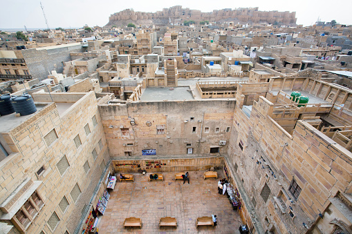 Jaisalmer, India - February 1, 2015: Courtyard and stone houses in poor area of historical indian town on February 1, 2015. Jaisalmer lies in the heart of the Thar Desert and has a population of about 78,000.