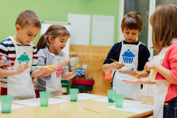 istock Children Painting Their Hands With Watercolors 516767614