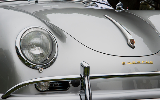 Dana Point, CA, USA - July 21, 2013: The front bumper, hood, headlight, intake vents, and badges of a masterfully restored and maintained vintage, Silver Metallic Porsche Speedster, at the Annual 356 Club of Southern California Dana Point Concours, which took place at Lantern Bay Park.