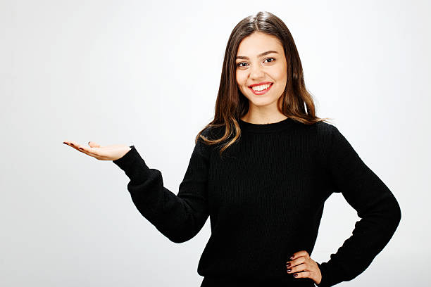 istock Young woman holding your product 516769674