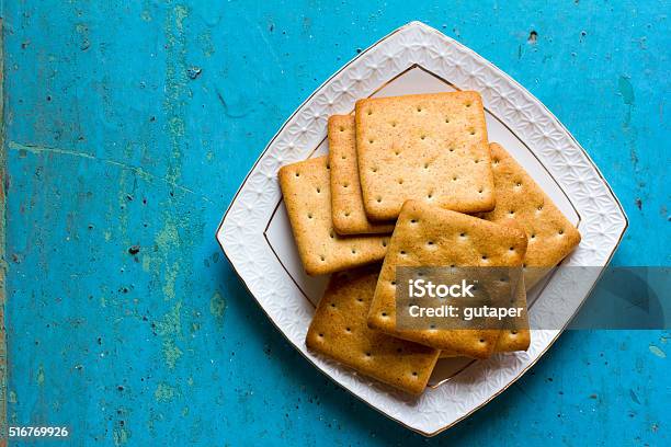 Cracker Biscuits In A White Ceramic Square Saucer Stock Photo - Download Image Now - Cracker - Snack, Plate, Ancient