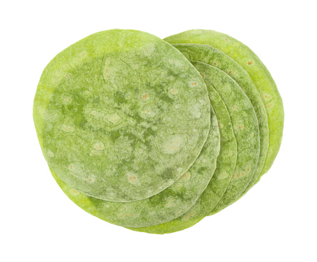 A group of green spinach wraps on a white background.
