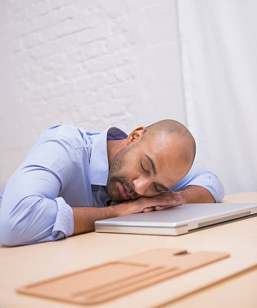 istock Businessman sleeping by laptop at desk 516779821