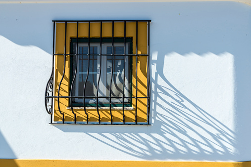 barred window in Evora, Portugal. Since 1996, Evora is declared World Heritage by UNESCO