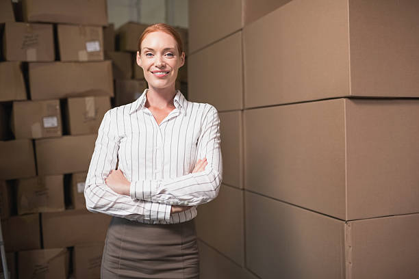 istock Female manager with arms crossed in warehouse 516782325