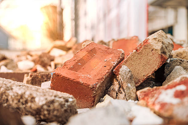 Rubble in container Rubble in container with sun effect pile of brick debris stock pictures, royalty-free photos & images