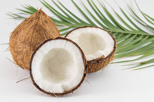 istock Halved and whole fresh coconuts with leaves 516787502