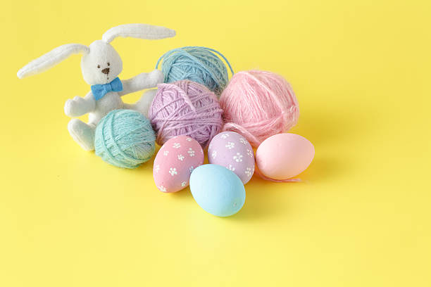 istock Colorful handmade easter eggs with wool clew and toy rabbit 516789456