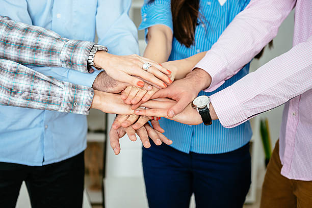 istock Group of successful business people making hands clasped in office 516791580