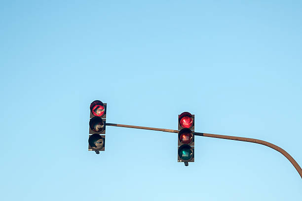 istock traffic lights showing red in all directions, blue sky 516791852