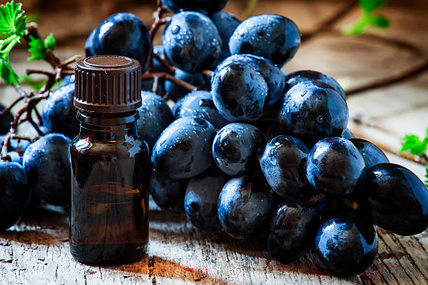 istock Essential oil of grape, vine, blue grapes 516792190