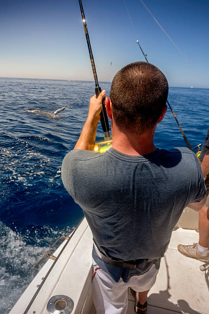 istock Man Catching Big Fish in Ocean 516793162