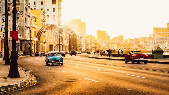 Traffic at Malecon road, Havana, Cuba, Latin America at sunset. Malecon (Avenida de Maceo) is 8 km (5 miles) starting from Havana Harbor in Old Havana and ending at Vedado.