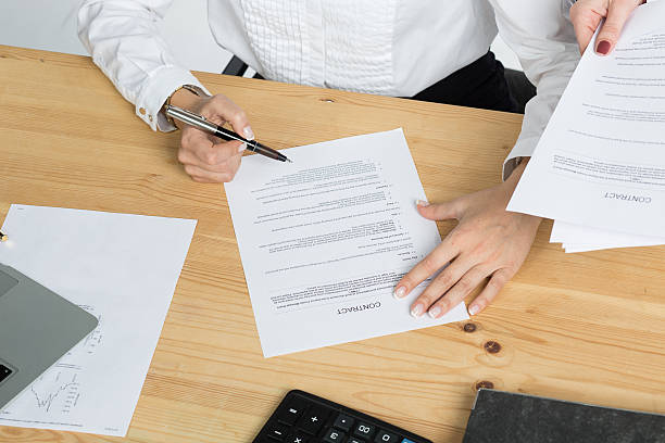 istock woman thinking about signing a contract 516795670