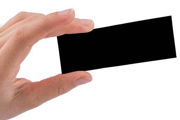 istock Piece of black paper in hand 516797542