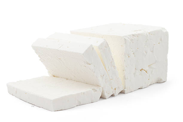 White cheese Sliced fresh white cheese from cow's milk on white background feta cheese block stock pictures, royalty-free photos & images