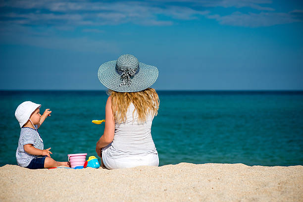 istock Young beautiful mother with her little boy on the beach 516797682