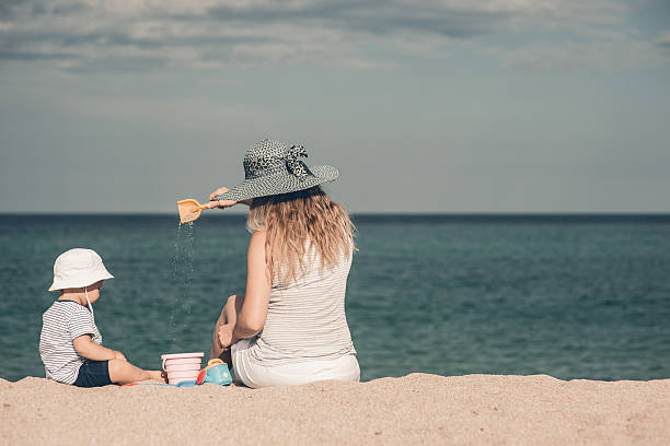istock Young mom with hat palying with her kid 516797970