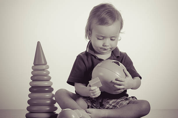 istock happy baby boy playing with toy 516799084