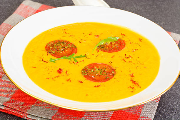istock Pumpkin Soup with Carrot and Cherry Tomatoes, Saffron, Dried Her 516800024