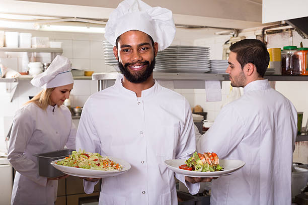 istock chef and his assistants preparing meal 516800638
