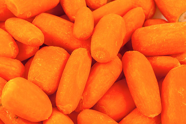 istock organic small baby carrots isolated on a white background 516801568