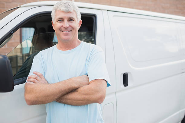 istock Smiling man in front of delivery van 516808749