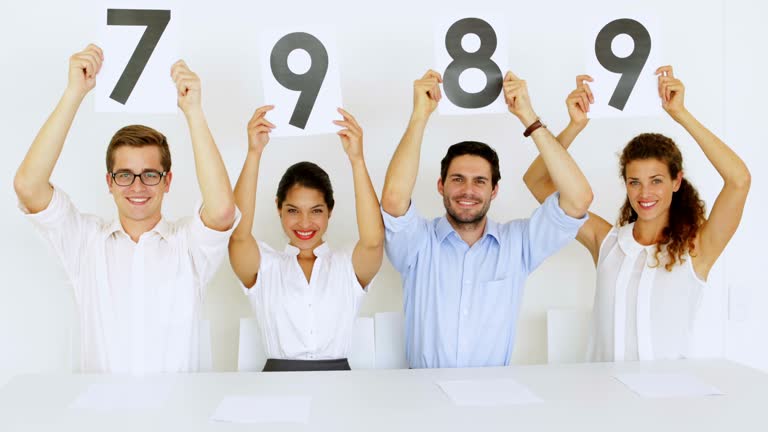 Interview panel holding up high scores