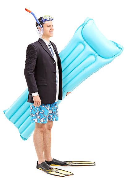 Man with suit and snorkel carrying swimming mattress isolated on white background