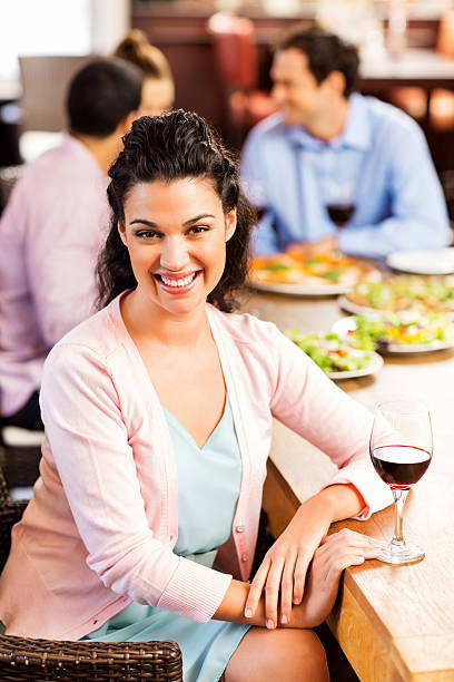 istock Woman With Red Wine Glass Sitting At Restaurant Table 516811431