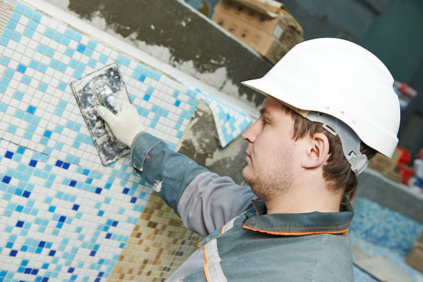 industrial tiler builder worker installing floor tile at repair renovation work