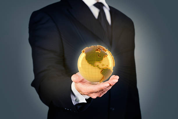 istock Businessman holding a golden globe 516814099