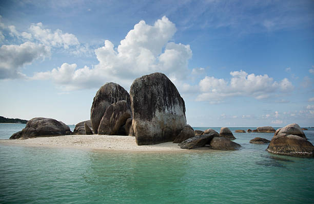 istock Huge rocks on a sandy little island, in Indonesia 516814447